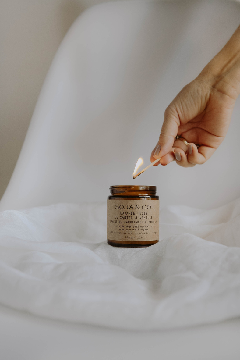 Person Holding Clear Glass Jar With White Powder